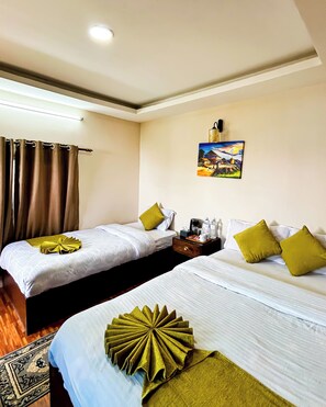 A hotel room with two beds, a nightstand, a painting on the wall, and a window with curtains.