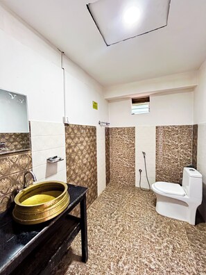 A bathroom with a sink, toilet, and shower.