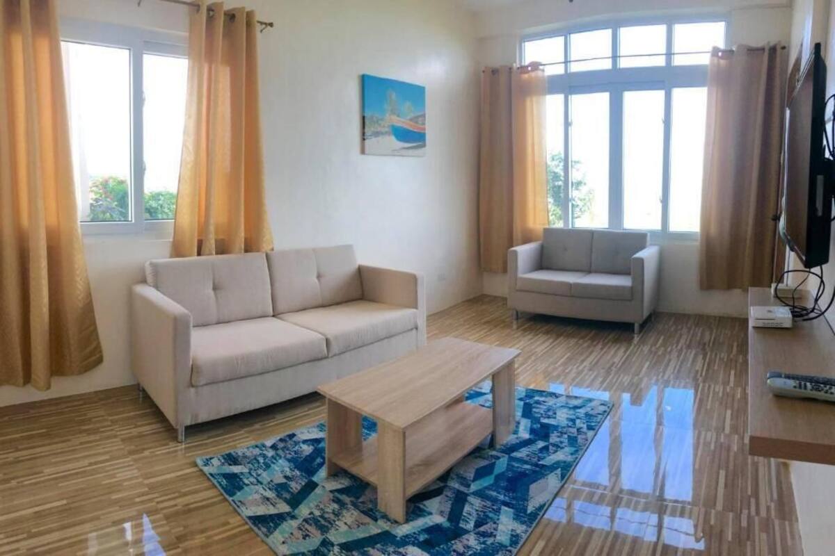 A living room with two sofas, a coffee table, and a TV.