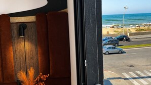 A modern interior with a view of the beach and parked cars. - Oceana Mazagan Suites Hotel  (El Jadida)