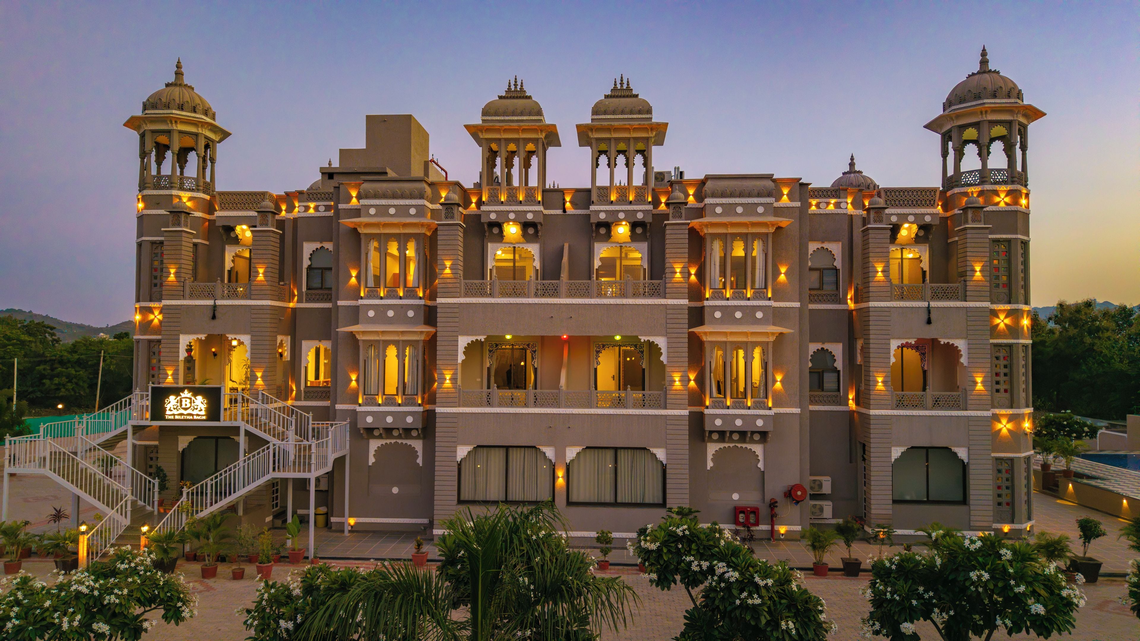 A multi-story building with balconies, a staircase, and a sign indicating 'The Biletha Bach'.
