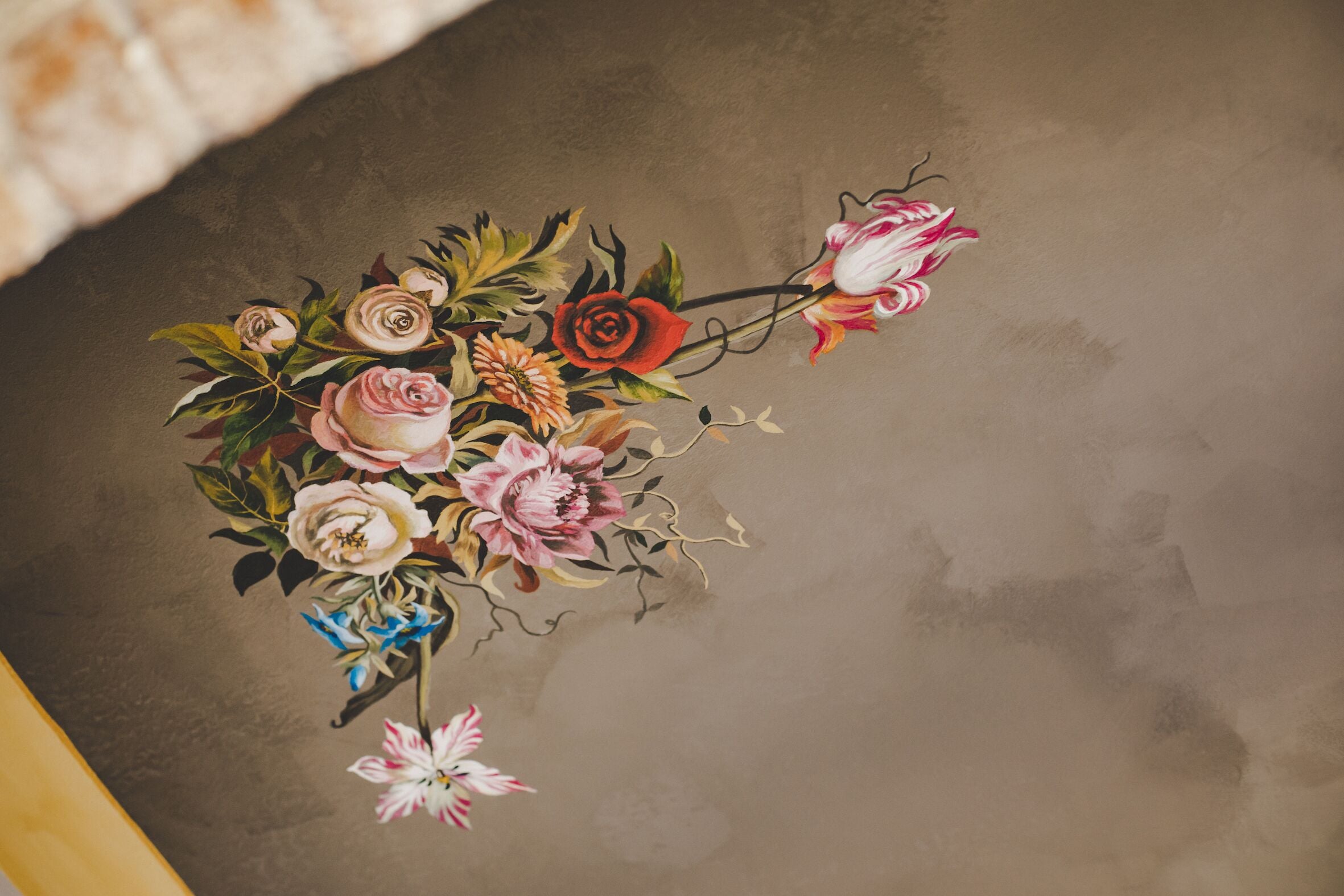 A wall with a floral mural.
