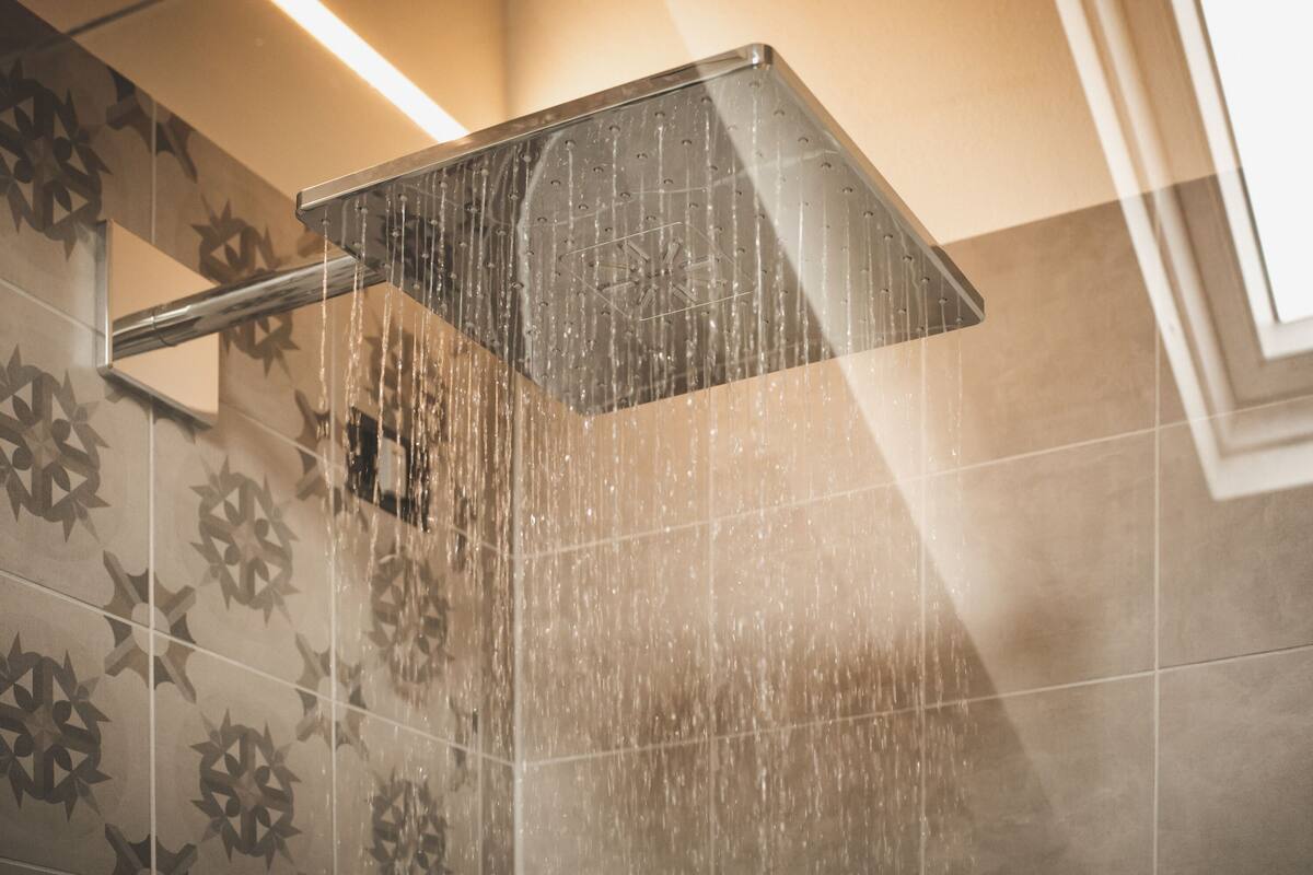 A showerhead with water running.
