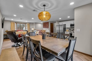 A modern kitchen with white cabinets, a stainless steel refrigerator, and a built-in oven. - #29 - Modern 5 Bedroom/2 Bath (Middletown)
