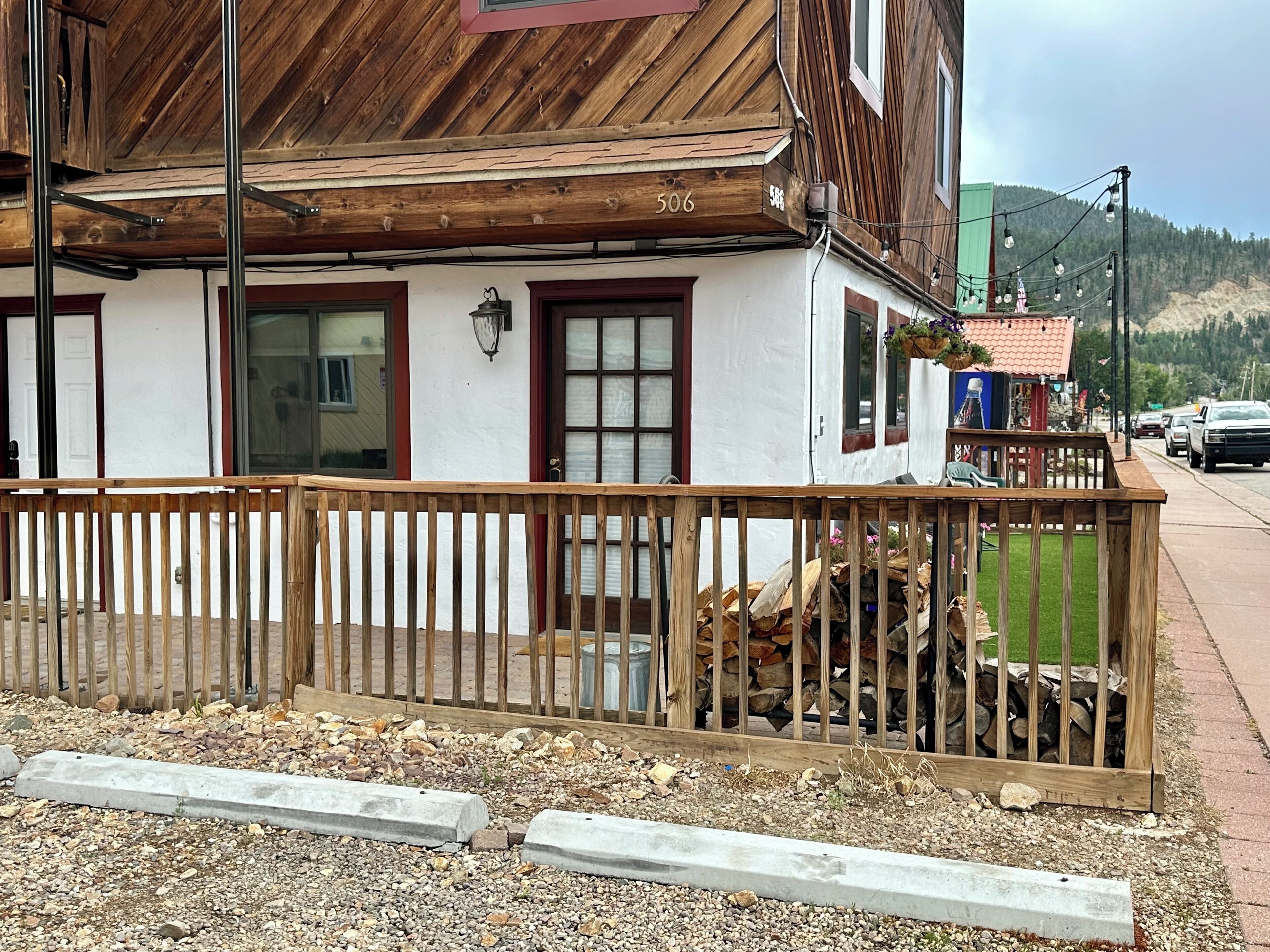 A building with a wooden balcony, a door, and a window.