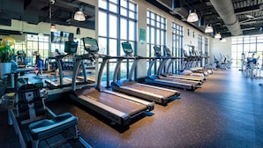 A gym with multiple treadmills and exercise equipment. - Splendid 5Bd w Pool at Solara Resort 2154 (Kissimmee)