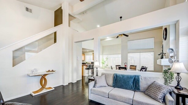A modern living room with a sofa, a coffee table, and a staircase. - Chic Vegas Retreat: Near Top Attractions (Las Vegas)