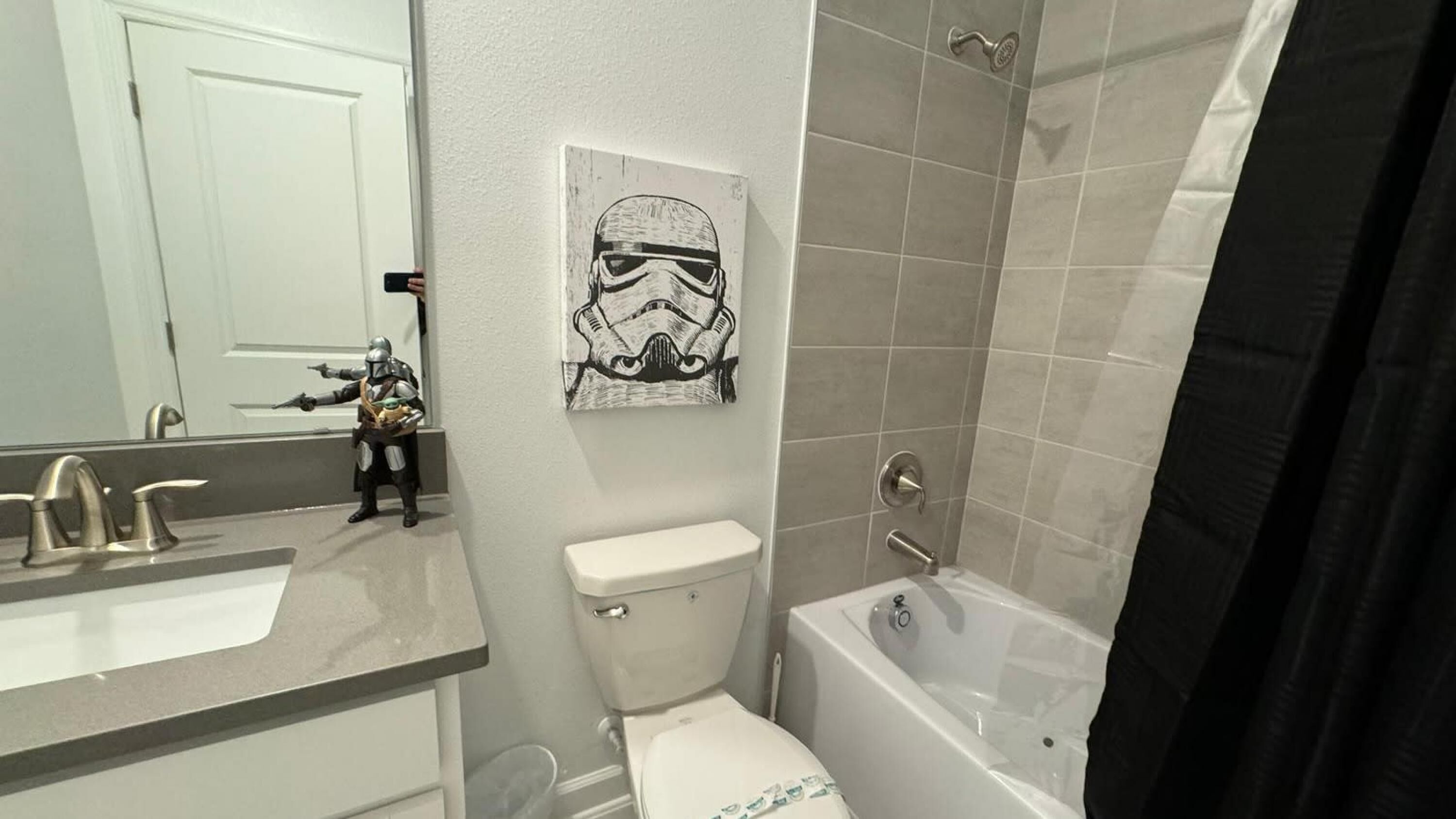 A bathroom with a toilet, sink, and bathtub.