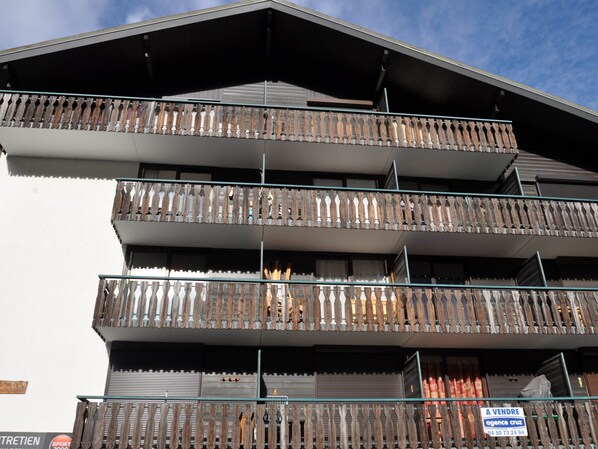 A multi-story building with balconies.