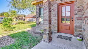 A brick house with a red door, a small porch, and a welcome mat. - Small Private House Near Best Places (Brownsville)