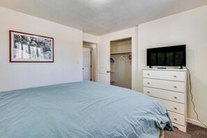 A bedroom with a bed, a dresser, a television, and a closet. - 4 Mi to Olde Town Arvada! Dog-friendly Home, Yard (Arvada)