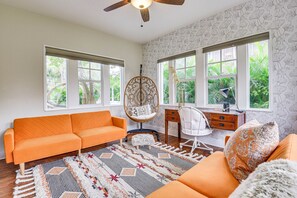 Relax in a stylish living room with a large sofa, desk, and patterned rug.