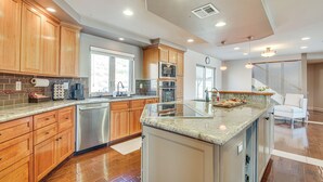 A modern kitchen with wooden cabinets, stainless steel appliances, and a large island. - Expansive Mountain Gem: Game Room, 3 Mi to Acton (Acton)