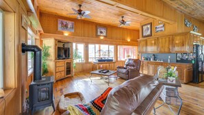A spacious living room with a fireplace, leather sofa, and a dining area. - Salmon Vacation Rental w/ Mountain Views! (Salmon)