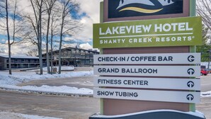 A sign for Lakeview Hotel at Shanty Creek Resorts with amenities including a check-in/coffee bar, grand ballroom, fitness center, and snow tubing. - Bellaire Condo - Walk to Shanty Creek Resort! (Bellaire)
