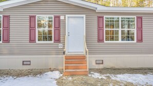 A single-story house with a front door, two windows with shutters, and a small set of steps leading to the door. - < 1 Mi to Beach: Peaceful Brant Lake Home! (Brant Lake)