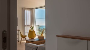 A modern room with a large window, a desk, a chair, and a sofa. - Modern sea Front Sea Waves (Alicante)