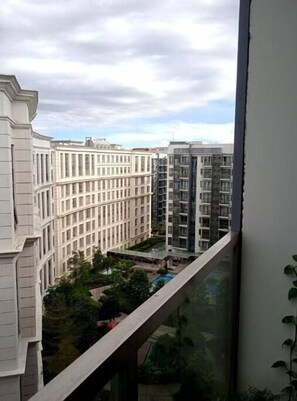 Overlooking a tranquil residential area with modern apartment buildings and a serene green space.