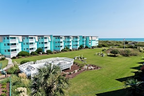 A multi-story hotel with balconies, a swimming pool, and a view of the ocean. - SeaSpray 355, Oceanview Condo in Atlantic Beach, NC! (Atlantic Beach)