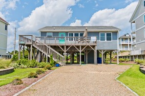 A two-story building with a covered porch and a staircase leading to a deck. - Starbird, Almost Oceanfront House in Emerald Isle, NC! (Emerald Isle)