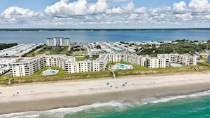 A coastal hotel with multiple buildings, a beach, and a large body of water. - Summer Winds 221, Oceanfront Condo in Indian Beach, NC! (Indian Beach)
