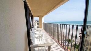 A balcony with white chairs and a view of the beach. - Summer Winds A-505, Oceanfront Condo in Indian Beach, NC! (Indian Beach)