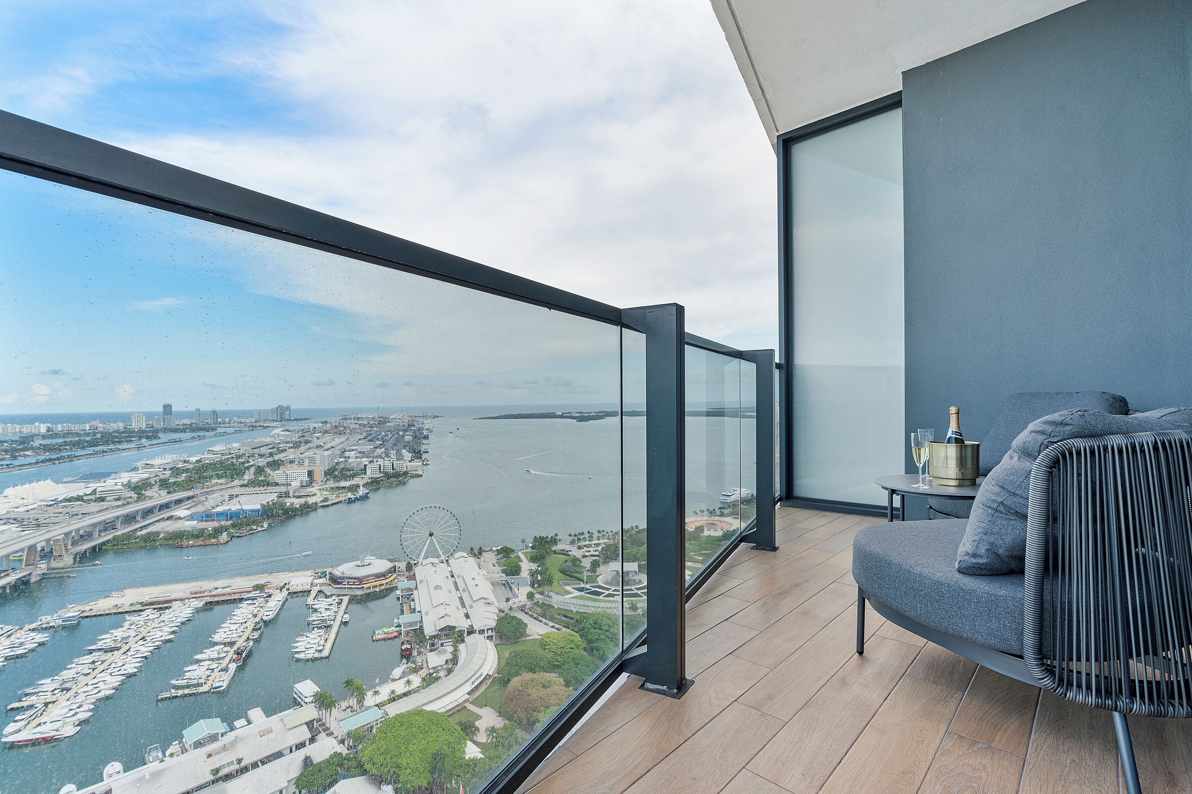 A balcony with a view of a marina and cityscape.