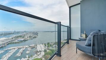 A balcony with a view of a marina and cityscape.