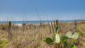 A beach with a wooden fence and sparse vegetation. - Sea Marsh I 104 - 3BD/2.5BA - Oceanfront (North Myrtle Beach)