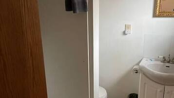 A bathroom with a bathtub, toilet, sink, and a towel rack.