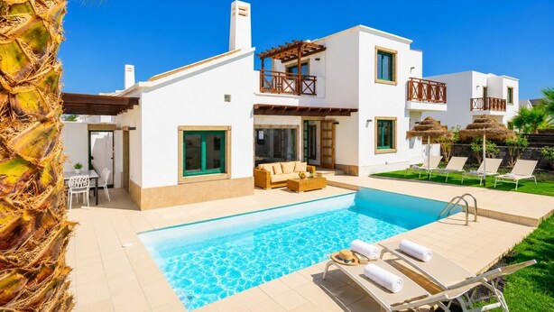 A modern two-story house with a swimming pool, outdoor seating, and a well-maintained garden. - Villa Dacil - Three Bedroom Villa, Sleeps 6 (Playa Blanca)