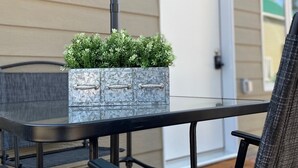 A patio with a glass-top table, metal chairs, and a potted plant. - The Cottages @Gull&Castle #2
LOCATION, LOCATION, LOCATION!
Downtown Wasagaming

 (Wasagaming)