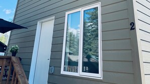 A two-story house with a gray siding exterior, white trim around windows and doors, and a visible number '2' on the side. - The Cottages @Gull&Castle #2
LOCATION, LOCATION, LOCATION!
Downtown Wasagaming

 (Wasagaming)