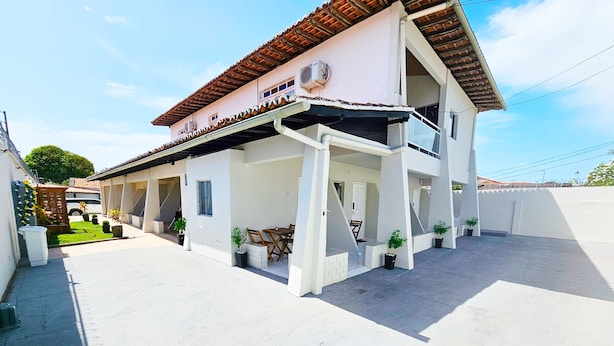 A two-story building with a covered outdoor area, multiple windows, and a tiled roof. - Jf Studio Hotel (São Luís)