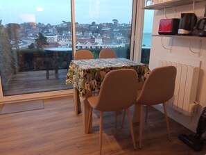 Enjoy a view of the surrounding residential area from the large window, with a table for meals and a convenient coffee station.