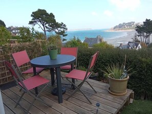 Enjoy a tranquil moment on this deck overlooking the sea with a clear view of the distant shoreline.