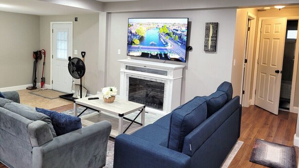 A living room with a fireplace, a television, and a sofa.