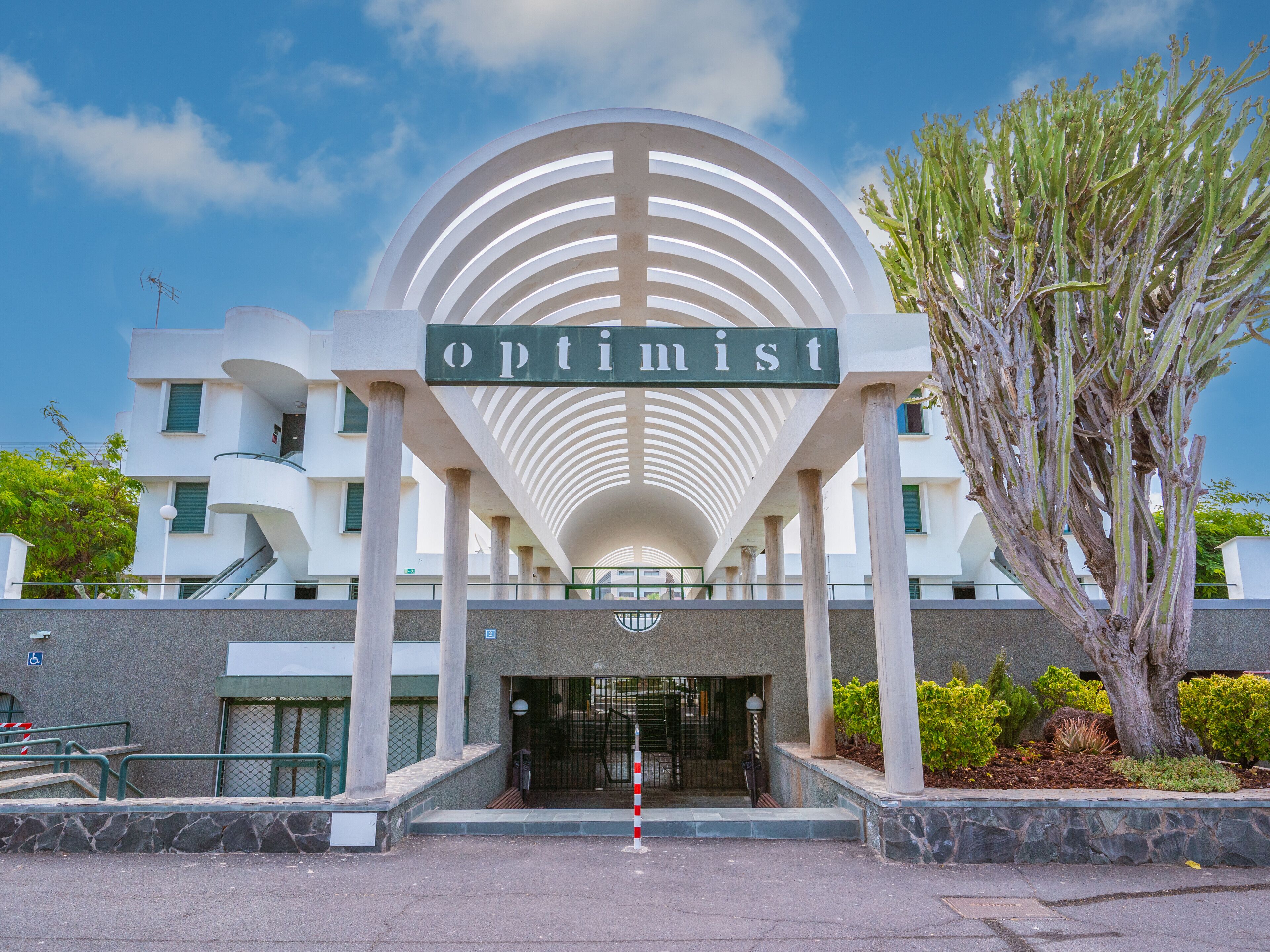 A building with a large sign reading "optimist" above the entrance.