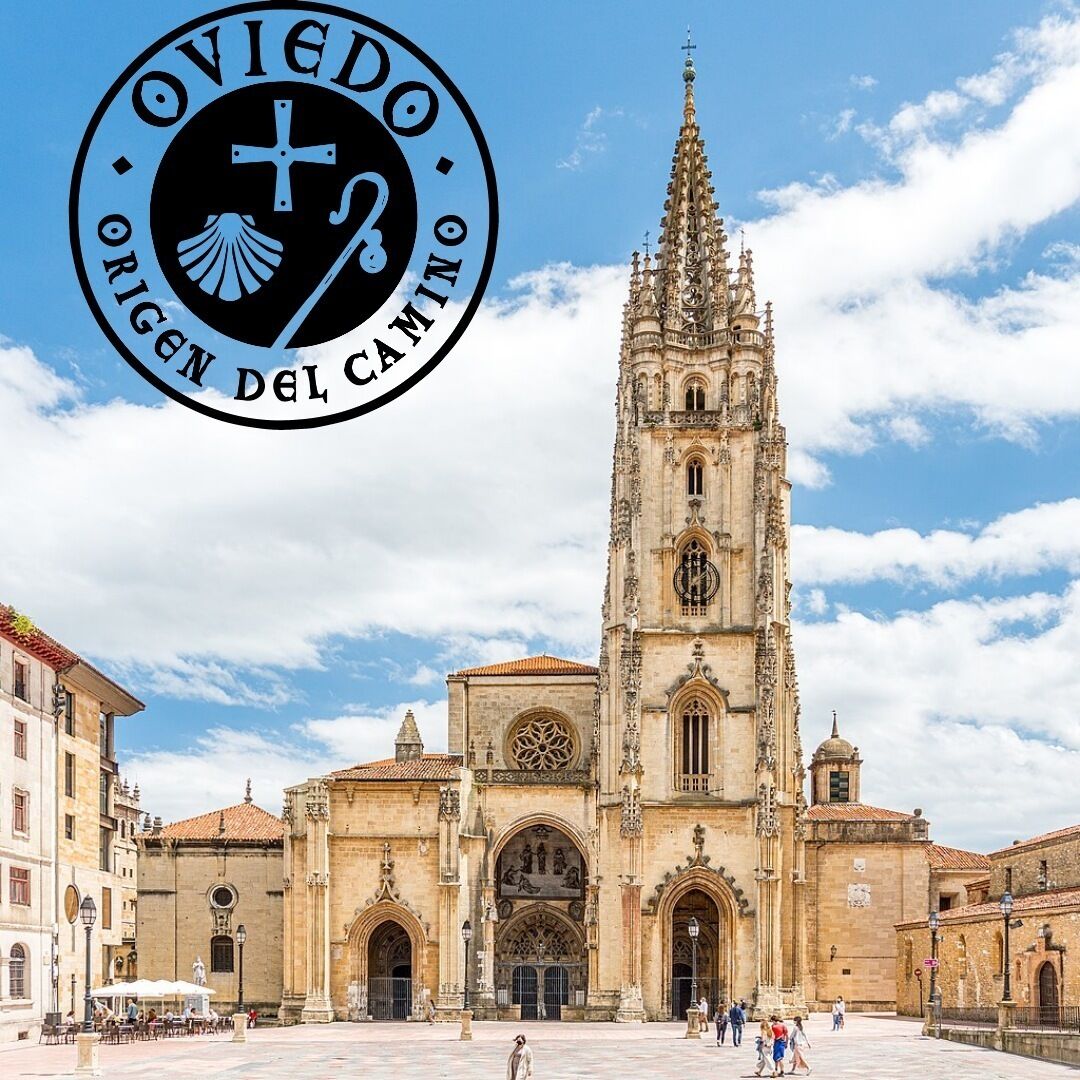 A historic cathedral with a tall spire, large arched windows, and intricate stonework.