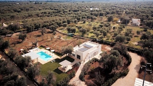 A large, modern house with a swimming pool, surrounded by a vast landscape with trees and open fields. - Villa Belkis 6, Emma Villas (Ostuni)