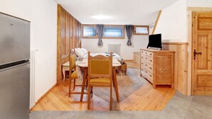 A bedroom with a bed, wooden wardrobe, desk, and a window with curtains. - Studio Apartment 'Premesan 4' with Wi-Fi (Bormio)