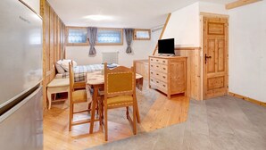 A bedroom with a bed, a desk, a chair, a dresser, a radiator, and a window. - Studio Apartment 'Premesan 4' with Wi-Fi (Bormio)