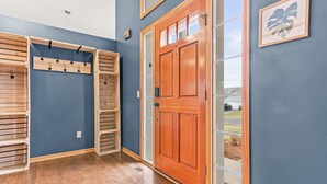 A room with a wooden door, a coat rack, and a framed picture on the wall. - Wonderful home in prime Rosemount location.

 (Rosemount)