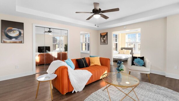 A modern living room with a sofa, armchair, and coffee table. - Affordable 1-BR by DMC Detroit (Detroit)