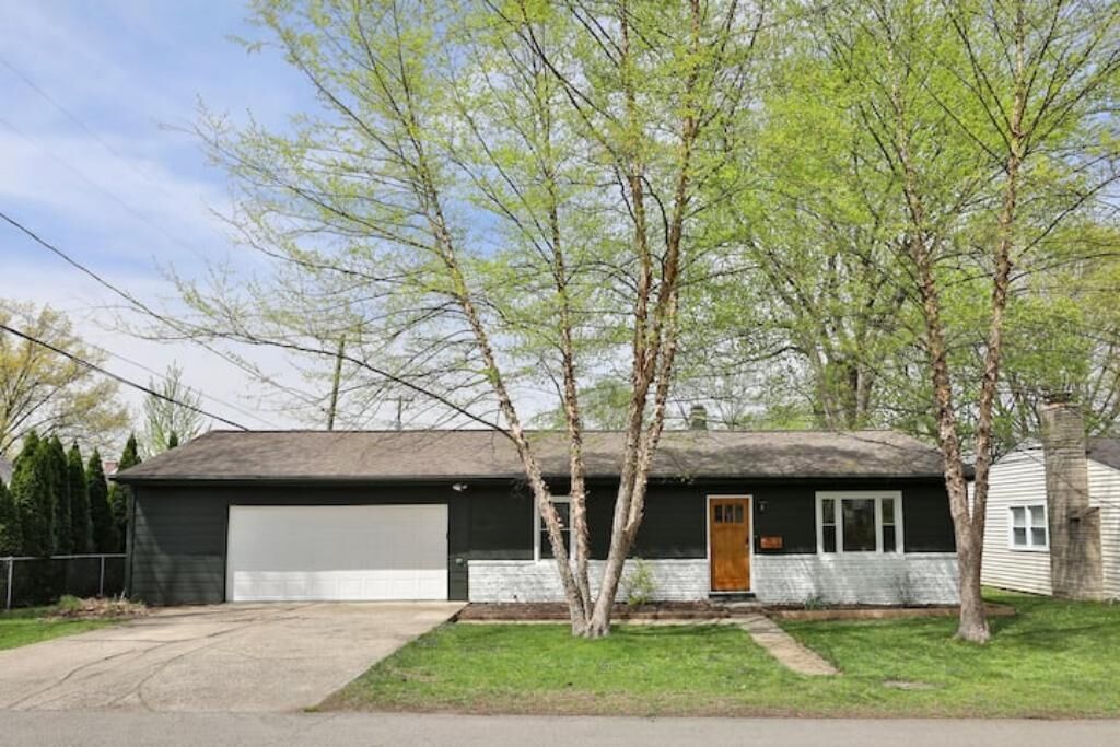 A single-story house with a garage, a front door, and a small porch area.