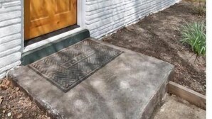 A house with a wooden front door, a small porch, and a mailbox. - Clintonville Cottage- Close to OSU & Downtown (Columbus)