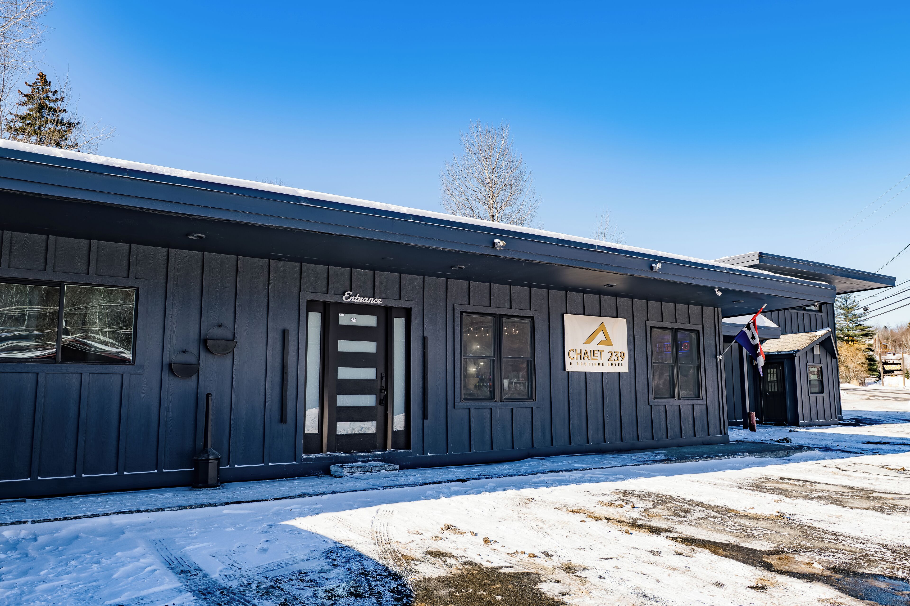 A building with a sign reading "Entrance" and "Chalet 239."