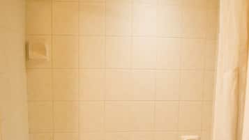 A bathroom with a bathtub, a shower, and a toilet.