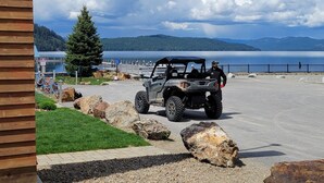 A sign for TYEE COFFEE CO. in front of a building with a view of a lake and mountains. - Adventure Cabin -Coolin Priest Lake; king bed, bunks, ATV and snowmobile parking (Coolin)