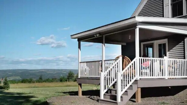 A two-story house with a covered porch and a view of the landscape. - Luxury on Seneca Wine Trail, 3 King Beds with Awesome Country View (Watkins Glen)